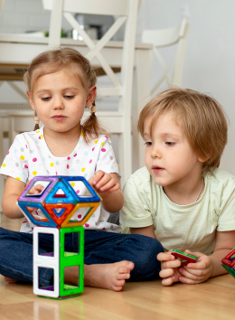 boy girl home playing with toys